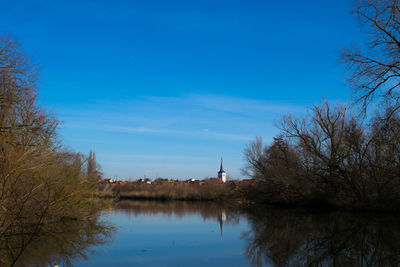 Scenic view of lake against blue sky