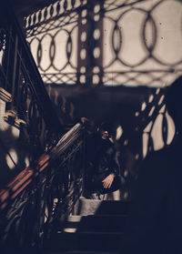 Man and woman standing on staircase in building