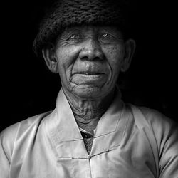 Portrait of mature man against black background