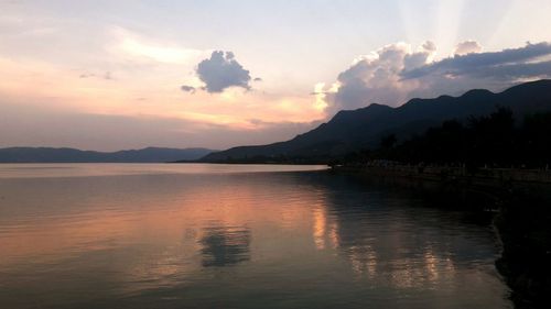 Scenic view of lake against sky during sunset