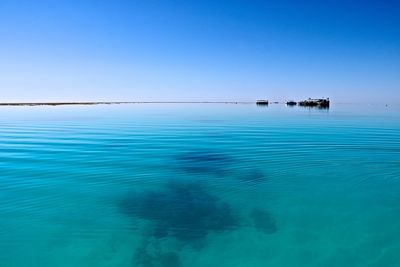 Scenic view of sea against clear blue sky