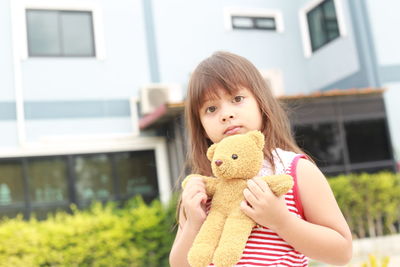 Portrait of happy girl holding toy