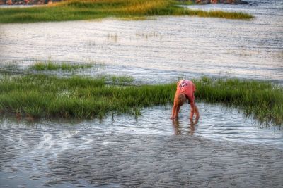 Full length of man walking in river