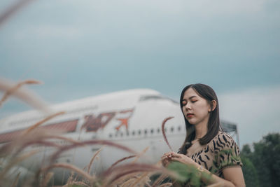 Woman looking away against sky