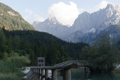 Scenic view of river and mountains against sky