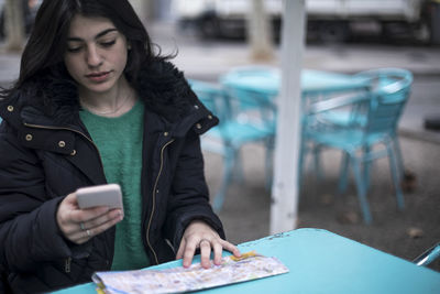 Portrait of young woman reading book