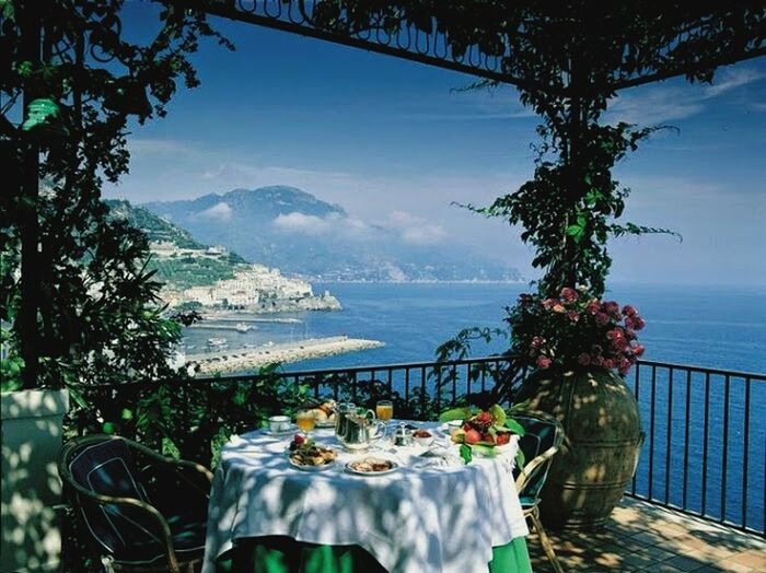 sea, water, sky, beauty in nature, nature, tree, horizon over water, mountain, flower, growth, tranquil scene, tranquility, potted plant, scenics, railing, beach, table, sunlight, plant, day