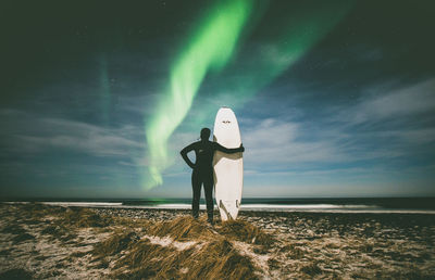 Man standing on beach against sky