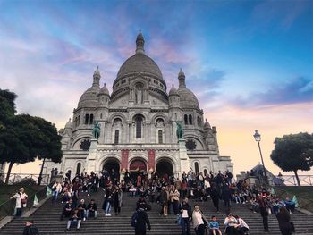 People at cathedral against sky