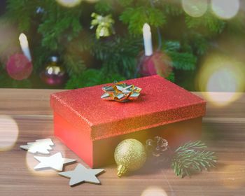 Close-up of christmas gift and decorations on table