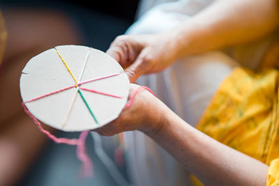 Close-up of woman making colorful decoration