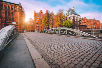 Bridge over canal amidst buildings in city