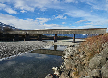 Bridge over river against sky