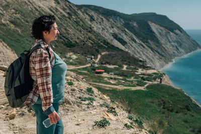 Rear view of man standing on mountain