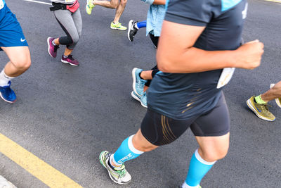 Low section of people running on road