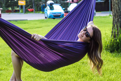 Young woman lying in hammock