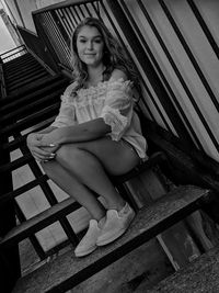 Portrait of woman sitting on staircase