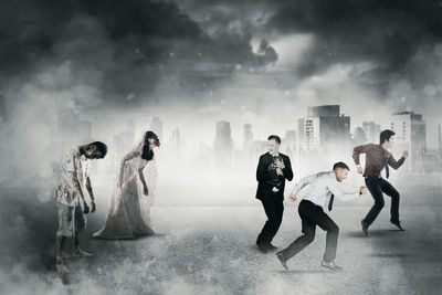 Group of people standing against cloudy sky