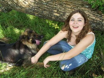 Portrait of smiling young woman sitting on grass