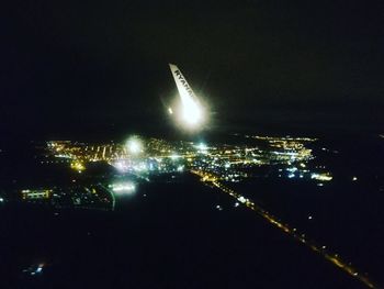 High angle view of city lit up at night