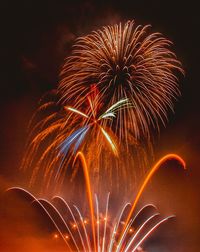 Low angle view of firework display at night