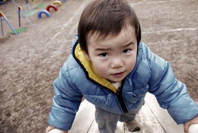 Portrait of cute boy playing at playground