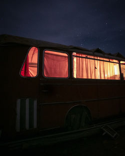 Low angle view of illuminated car window at night