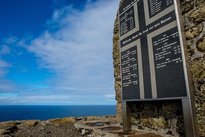 Tilt image of text on beach against sky