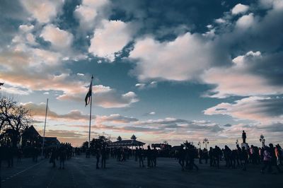 Silhouette people against sky during sunset