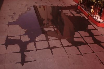 Reflection of silhouette person on street