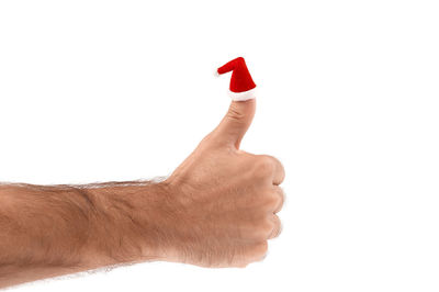 Cropped image of red holding umbrella against white background
