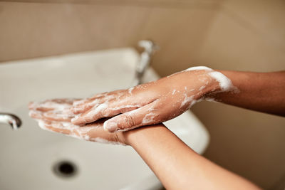 Cropped hand of person washing hands