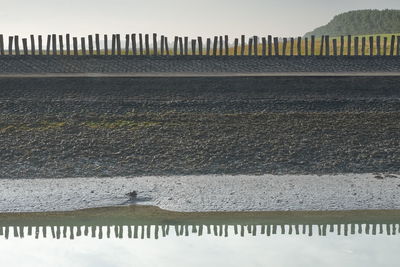 High angle view of fence on land against sky