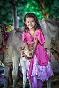 Portrait of smiling girl with pink umbrella