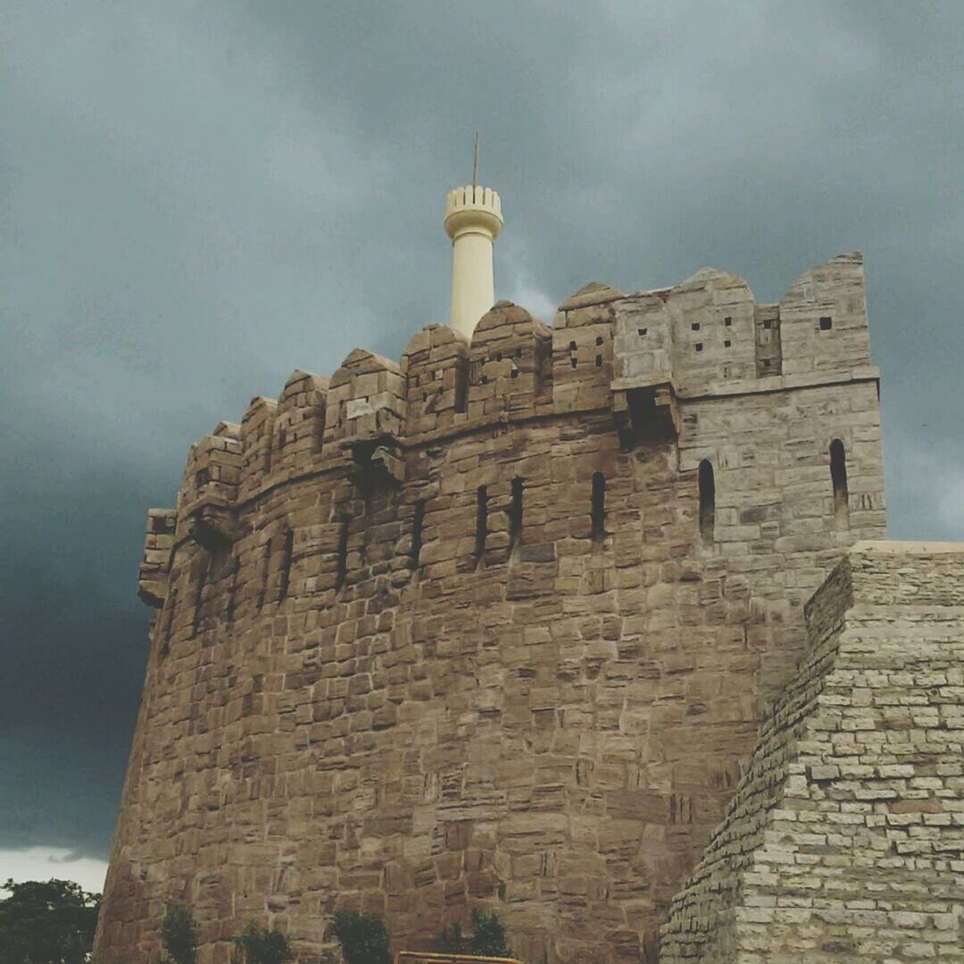 architecture, built structure, building exterior, sky, history, low angle view, cloud - sky, old, tower, stone wall, the past, castle, fort, wall - building feature, lighthouse, old ruin, day, outdoors, cloudy, ancient