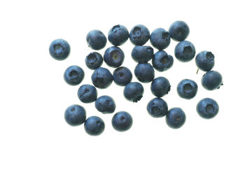 Close-up of blueberries against white background