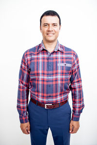 Portrait of smiling man standing against white background