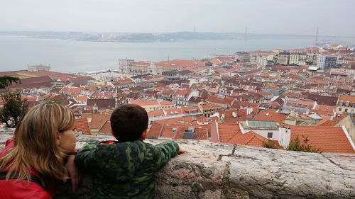 Mother and son against townscape