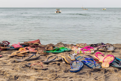 Deck chairs on beach against sea