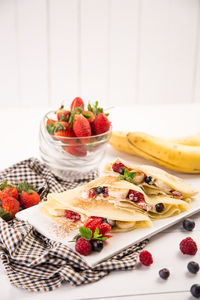 Close-up of fruits served in plate on table