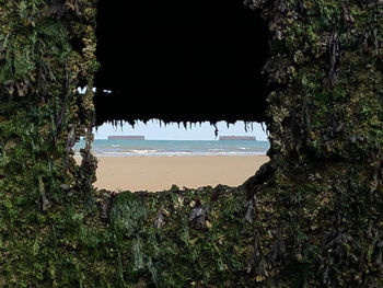 Scenic view of sea seen through cave