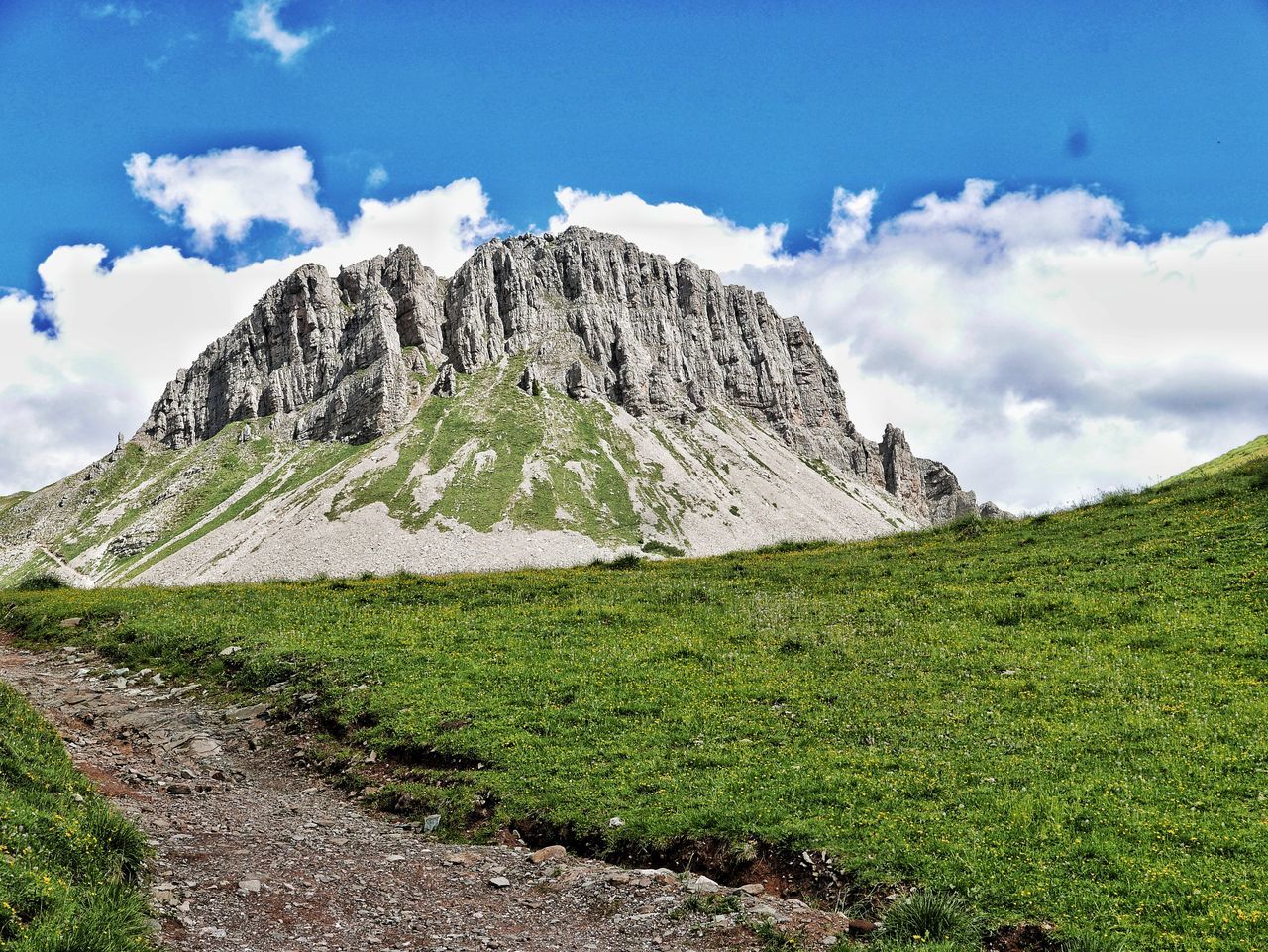 sky, mountain, landscape, environment, cloud, scenics - nature, mountain range, beauty in nature, nature, land, ridge, plant, plateau, mountain pass, grass, wilderness, travel destinations, travel, no people, meadow, highland, non-urban scene, green, rock, tranquil scene, tranquility, mountain peak, valley, tourism, outdoors, blue, day, walking, activity, grassland, outdoor pursuit, footpath, idyllic, adventure, snow, tree, leisure activity