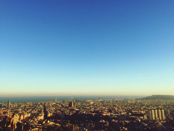 High angle view of cityscape against clear blue sky