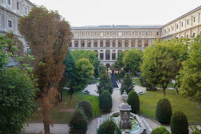 View of fountain in garden against buildings