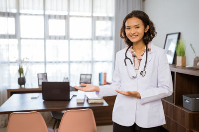 Portrait of female doctor standing in office