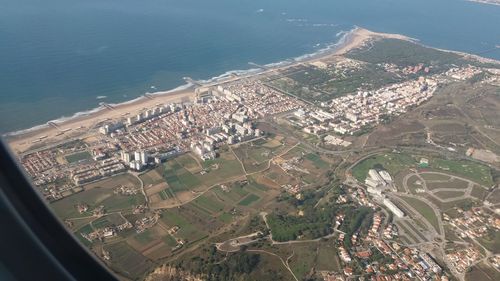 High angle view of buildings and sea in city