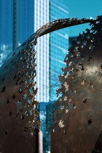 Close-up of glass building against sky