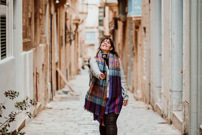 Portrait of smiling young woman standing outdoors