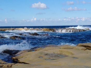 Scenic view of sea against blue sky