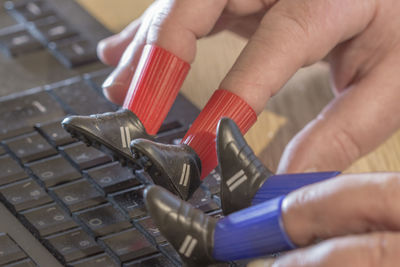 Cropped hands typing in keyboard